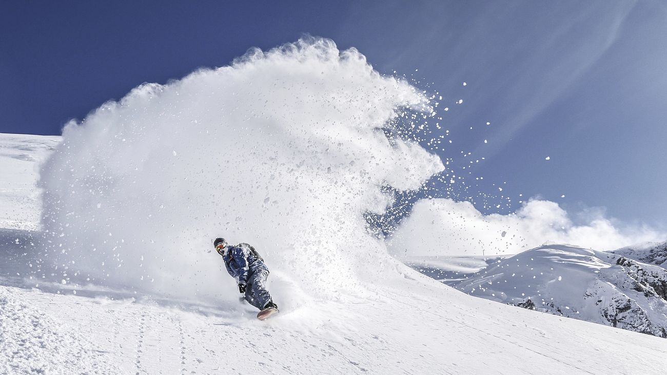 Free snowboarder in deep powder